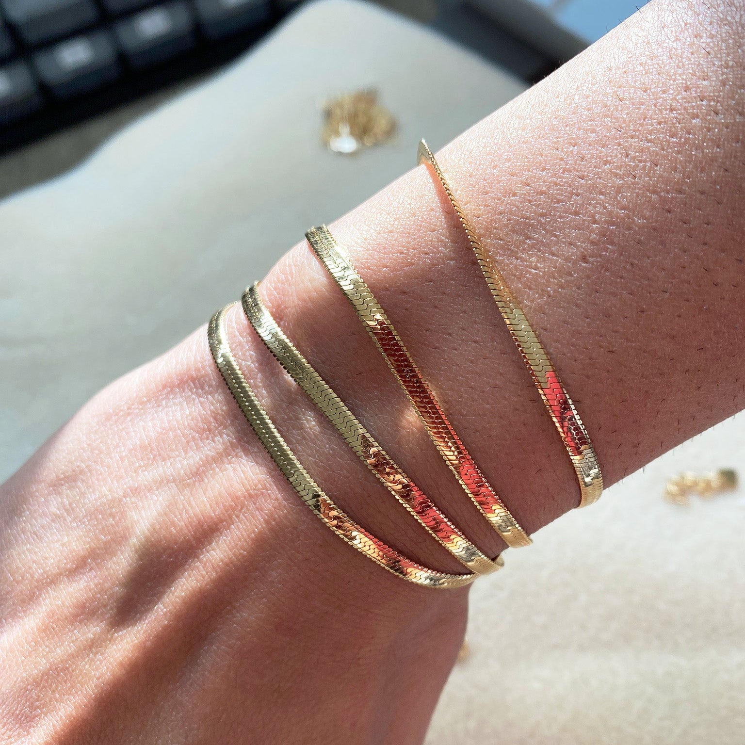 Model wearing the LucyKitty Gold Filled Mira Fine Herringbone Bracelet