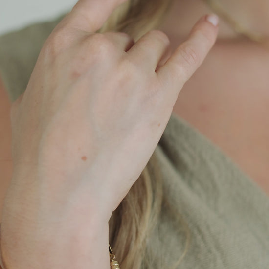 Model wearing the LucyKitty Gold Filled Mira Wide Herringbone Bracelet