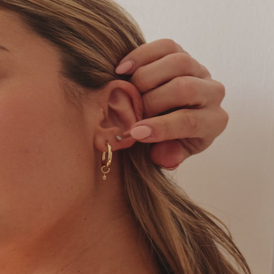 Model wearing LucyKitty Gold Filled Removable Charms Lily Hoop Earrings with Iris Birthstone Studs in March Aquamarine