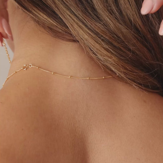 Model Clasping the LucyKitty Gold Filled Zia Chain Necklace with a Magnetic Clasp